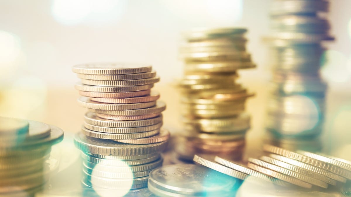 rows of coins and blurred bokeh for finance and banking concept